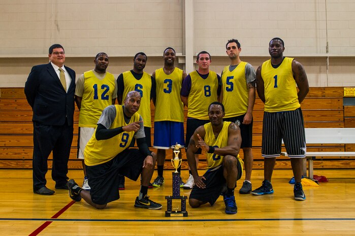 Members of the 628th Civil Engineer Squadron basketball team gather for a group photo after winning the 2013 Intramural Basketball Championship March 25, 2013, at JB Charleston - Air Base, S.C. The 628th CES beat the 628th LRS 48 to 30 to become JB Charleston's basketball champions. (U.S. Air Force photo/ Senior Airman George Goslin)