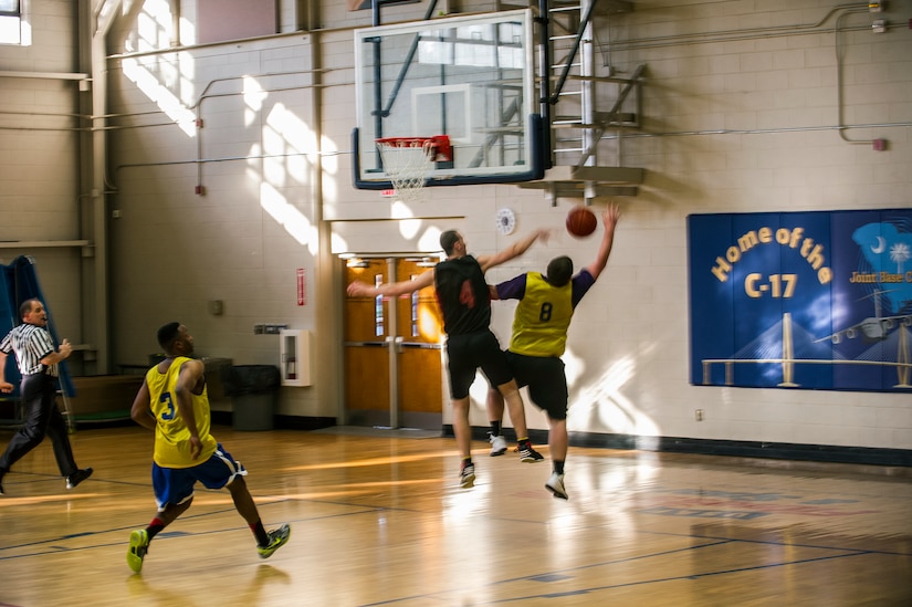 Richard Gilchrest, 628th Logistics Readiness Squadron, blocks a shot from Brian Haney, 628th Civil Engineer Squadron, during the Intramural Basketball Championship March 25, 2013, at Joint Base Charleston - Air Base, S.C. The 628th CES beat the 628th LRS 48 to 30 to become JB Charleston's basketball champions. (U.S. Air Force photo/ Senior Airman George Goslin)