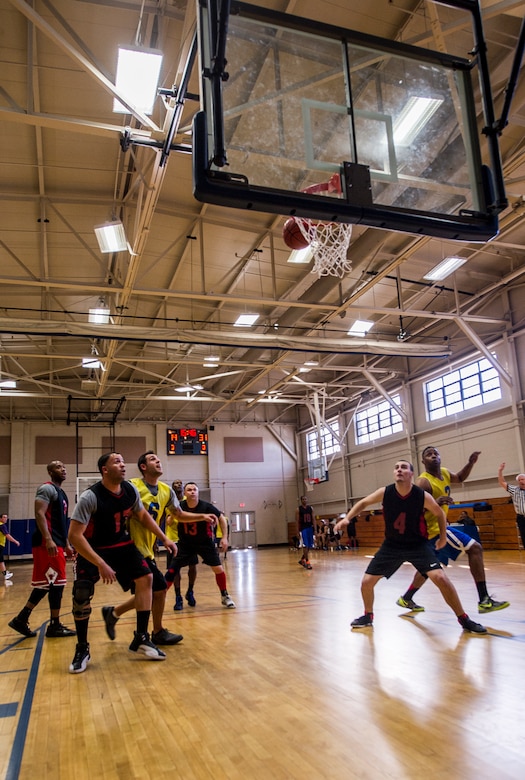 Players fight for a rebound during the Intramural Basketball Championship March 25, 2013, at Joint Base Charleston - Air Base, S.C. The 628th CES (gold) beat the 628th LRS (black) 48 to 30 to become JB Charleston's basketball champions. (U.S. Air Force photo/ Senior Airman George Goslin)