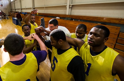 Members of the 628th Civil Engineer Squadron basketball team rally during halftime at the Intramural Basketball Championship March 25, 2013, at Joint Base Charleston - Air Base, S.C. The 628th CES beat the 628th LRS 48 to 30 to become JB Charleston's basketball champions. (U.S. Air Force photo/ Senior Airman George Goslin)