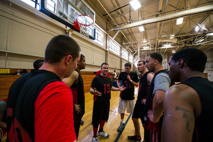 Robert Degregorio (center), 628th Logistics Readiness Squadron coach/player, discusses strategy with his teammates during the Intramural Basketball Championship March 25, 2013, at Joint Base Charleston - Air Base, S.C. The 628th CES beat the 628th LRS 48 to 30 to become JB Charleston's basketball champions. (U.S. Air Force photo/ Senior Airman George Goslin)