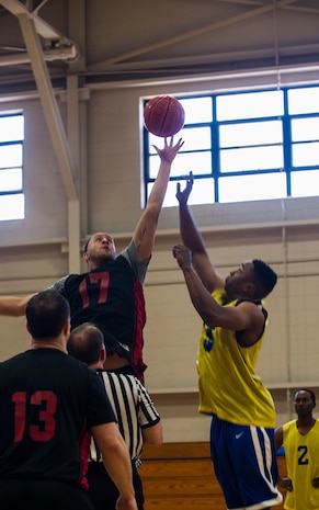 Jordan Pete, 628th Logistics Readiness Squadron, wins the tipoff against Jeston Freeman, 628th Civil Engineer Squadron, during the Intramural Basketball Championship March 25, 2013, at Joint Base Charleston - Air Base, S.C. The 628th CES beat 628th LRS 48 to 30 to become JB Charleston's basketball champions. (U.S. Air Force photo/ Senior Airman George Goslin)