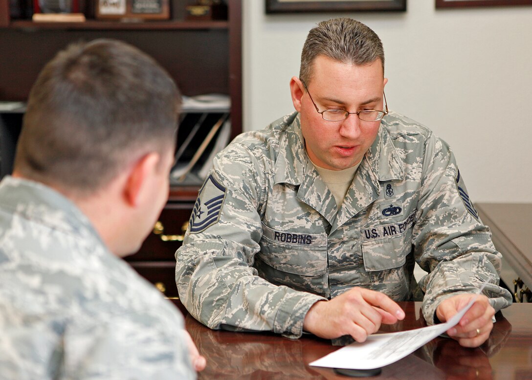 Master Sgt. Erik Robbins, 412th Test Wing career assistance advisor, goes over a list of available career options with a young Airman. Sergeant Robbins is located near the First Term Airman Center and is there to provide career assistance to Airmen who have questions about retention, cross training, or changing jobs. (U.S. Air Force photo by Jet Fabara)