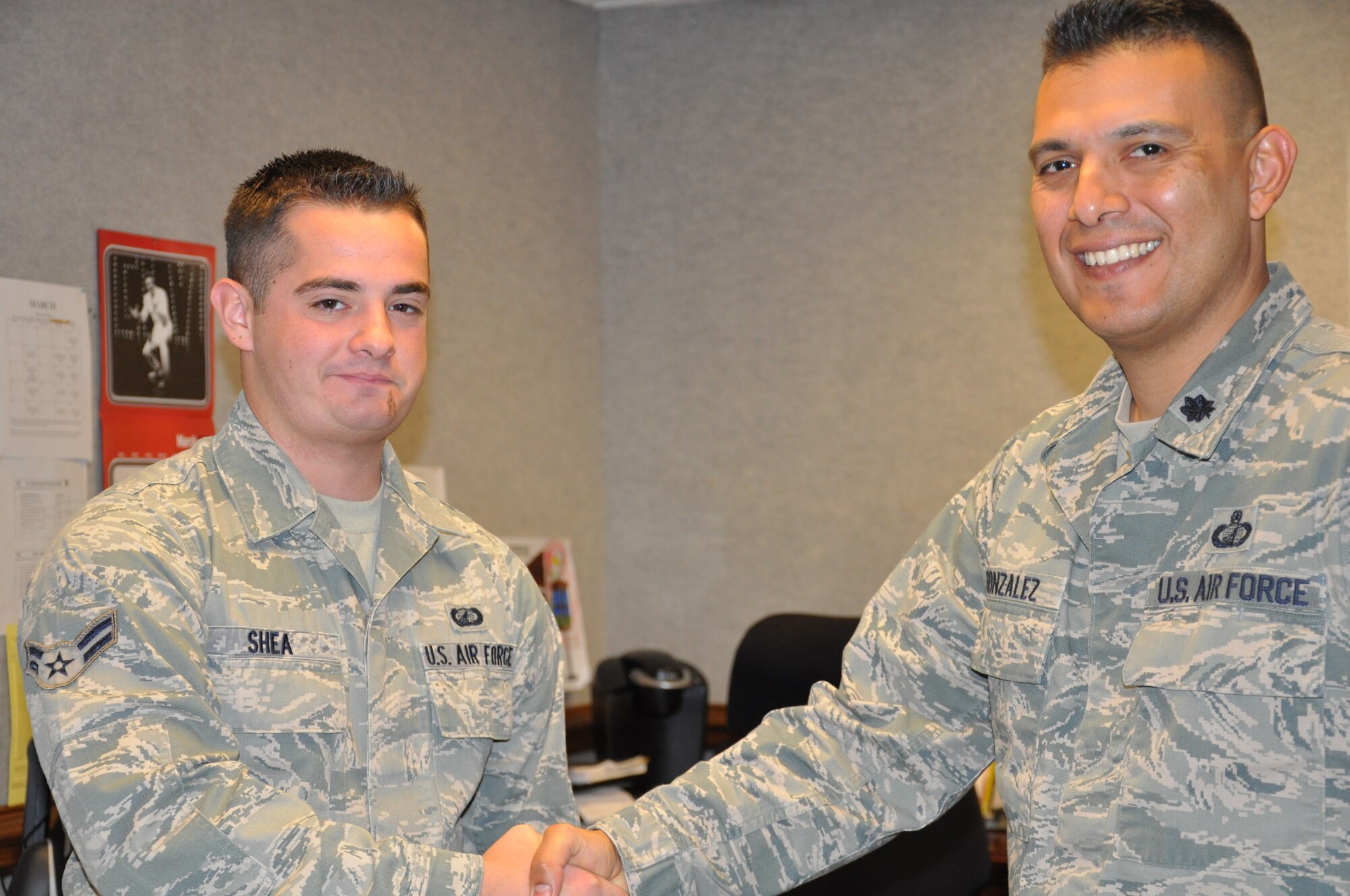 Airman 1st Class Anthony Shea, 325th Contracting Squadron , receives a congratulatory handshake from Lt. Col. Lt. Col. Antonio Gonzales, 325th CONS commander, for his below-the-zone promotion March 27. The BTZ program allows those in the rank of Airmen 1st Class to be promoted to Senior Airmen six months before they normally would. (U.S. Air Force photo by Ashley M. Wright)