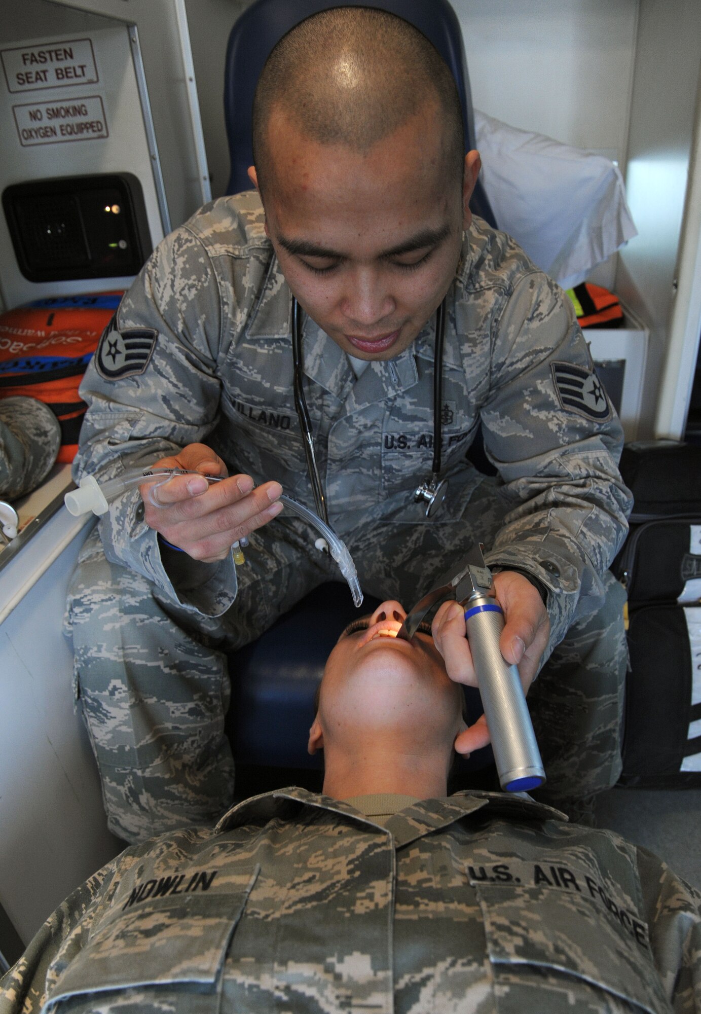 Staff Sgt. Marc Villano , 92nd Medical Operations Squadron NCO in charge of ambulance services, demonstrates how to intubate on Master Sgt. Kimberly Nowlin, 1st Sgt. of the 92nd Medical Group, at Fairchild Air Force Base, March 27, 2013. Villano manages daily operations of Fairchild’s ambulance service that provides around-the-clock response to medical, in-flight, and ground emergencies. (U.S. Air Force photo by Senior Airman Samantha Krolikowski)
