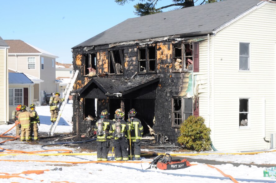 HANSCOM AIR FORCE BASE, Mass. – The Hanscom Fire Department, as well as firefighters from surrounding communities, respond to a house fire on Ent Road in Hanscom Family Housing March 24. Any community member who wishes to contribute to the family may call 781-845-1296, 781-845-1377 or email brent.whitby@hanscom.af.mil for further information. (U.S. Air Force photo by Linda LaBonte Britt)