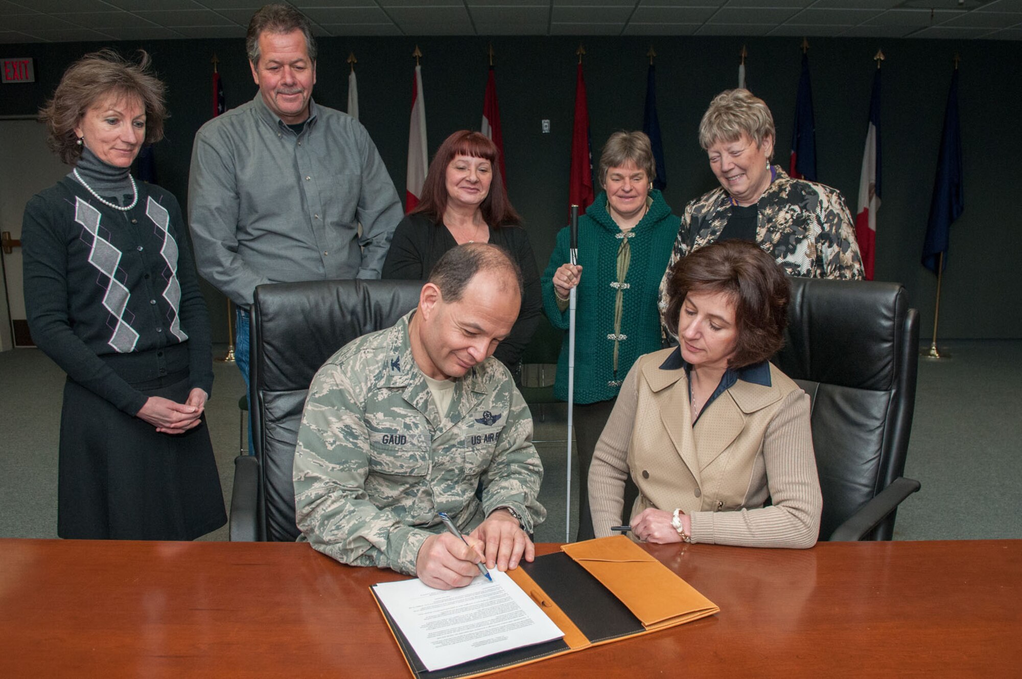 HANSCOM AIR FORCE BASE, Mass. - Col. Juan Gaud, 66th Air Base Group deputy director, and Marla Levenson, NAGE Local R1-8 president, sign a memorandum of agreement as a result of potential civilian furloughs during a meeting with union and labor relations representatives in the Brown Building March 18. The Department of Defense recently announced that furlough notices to civilian employees would be delayed until on or about April 5 in order to analyze legislation. (U.S. Air Force photo by Rick Berry)