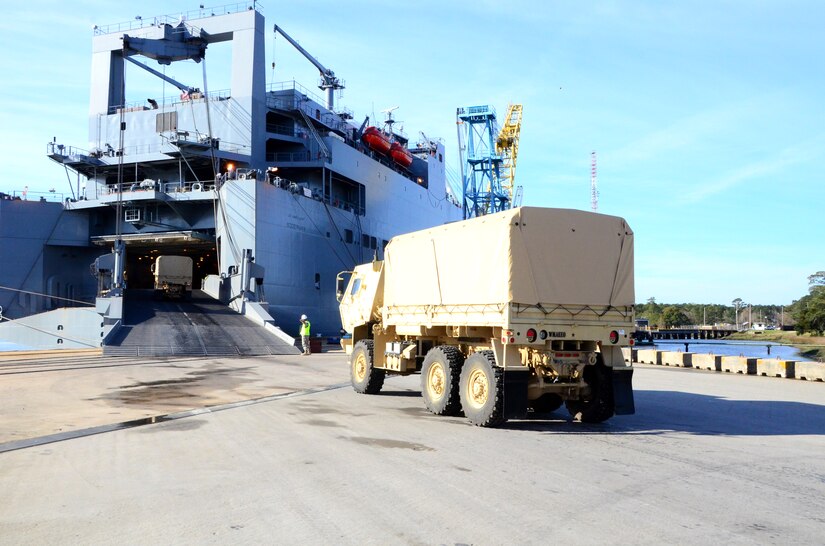U.S. Army Sgt. 1st Class Raymond Sapp , 841st Transportation Battalion transportation management coordinator, marshals trucks onto USNS Soderman (T-AKR 317) March 22, 2013, at Wharf Alpha on Joint Base Charleston - Weapons Station, S.C. The shipment will contain more than 1,600 military vehicles and 160 shipping containers. Once loaded, the vessel will contain more than 10,000 long tons of cargo and be prepositioned overseas. (U.S. Air Force photo/Staff Sgt. William O'Brien)