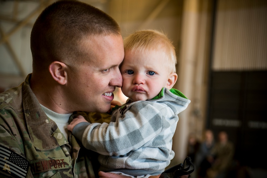U.S . Air Force Airman 1st Class Alex Newport, 74th Aircraft Maintenance Unit, hugs his son, Jett, March 26, 2013, at Moody Air Force Base, Ga. Newport and approximately 350 Airmen left Moody for a six-month deployment to Southwest Asia. (U.S. Air Force photo by Staff Sgt. Jamal D. Sutter/Released) 