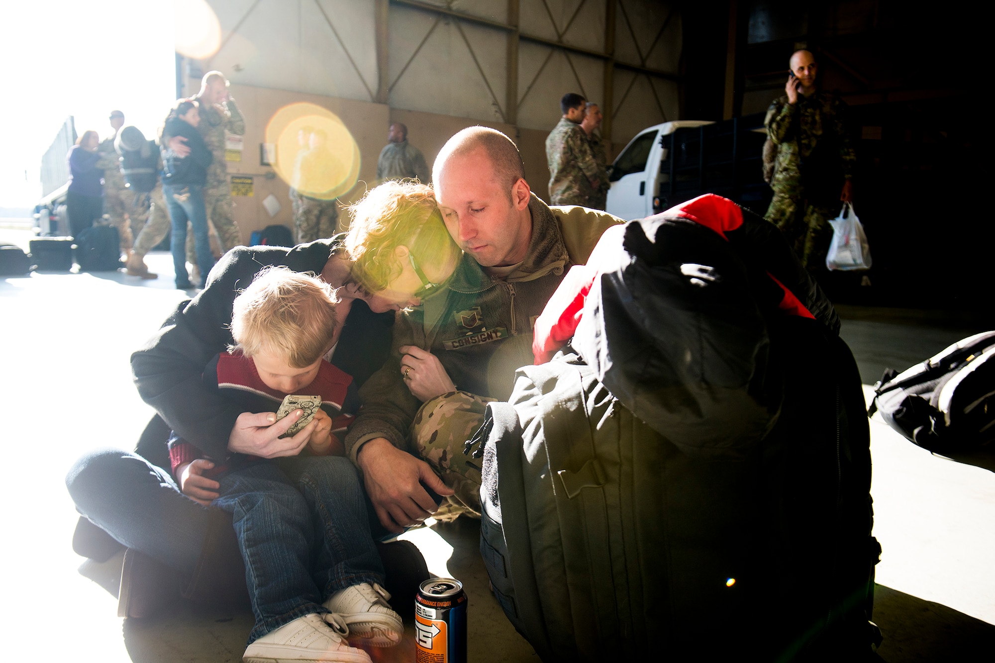 U.S. Air Force Tech. Sgt. Michael Consigny, 74th Aircraft Maintenance Unit, shares a few last moments with his wife, Christa, and son, Jack, March 26, 2013, at Moody Air Force Base, Ga. Consigny and approximately 350 Airmen left Moody for a six-month deployment to Southwest Asia. (U.S. Air Force photo by Staff Sgt. Jamal D. Sutter/Released)
