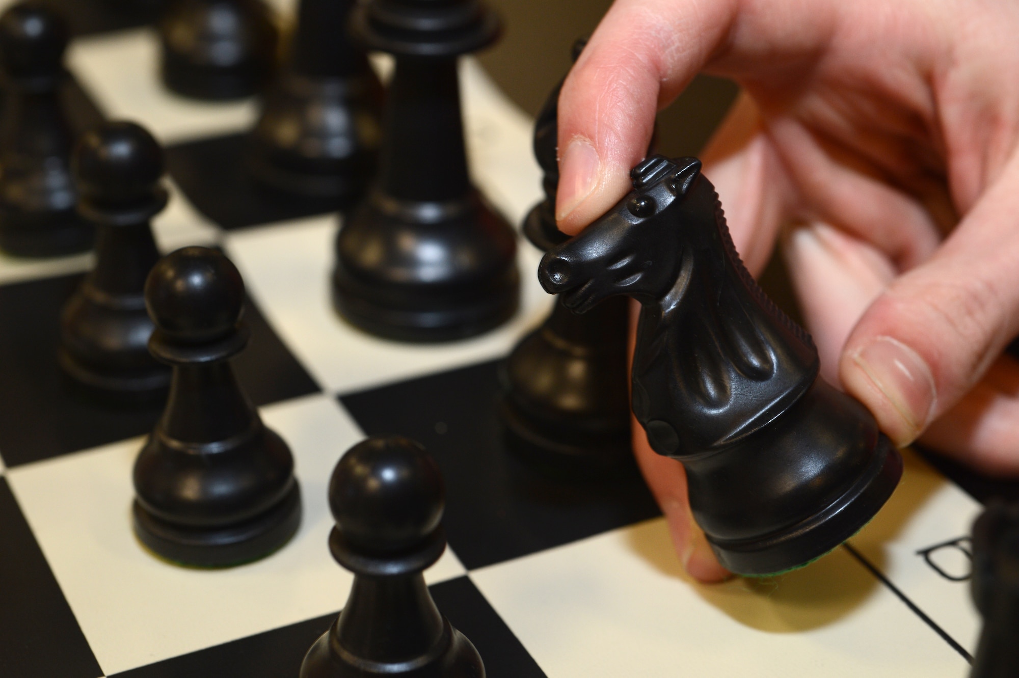 SPANGDAHLEM AIR BASE, Germany – Ethan Bell, from Cambridge, England, moves a chess piece March 24, 2013, in the Brick House at Spangdahlem Air Base. The 52nd Force Support Squadron offers these types of events to the Spangdahlem community as a way for gamers to come together and enjoy each others’ company. (U.S. Air Force photo by Airman 1st Class Kyle Gese/Released)