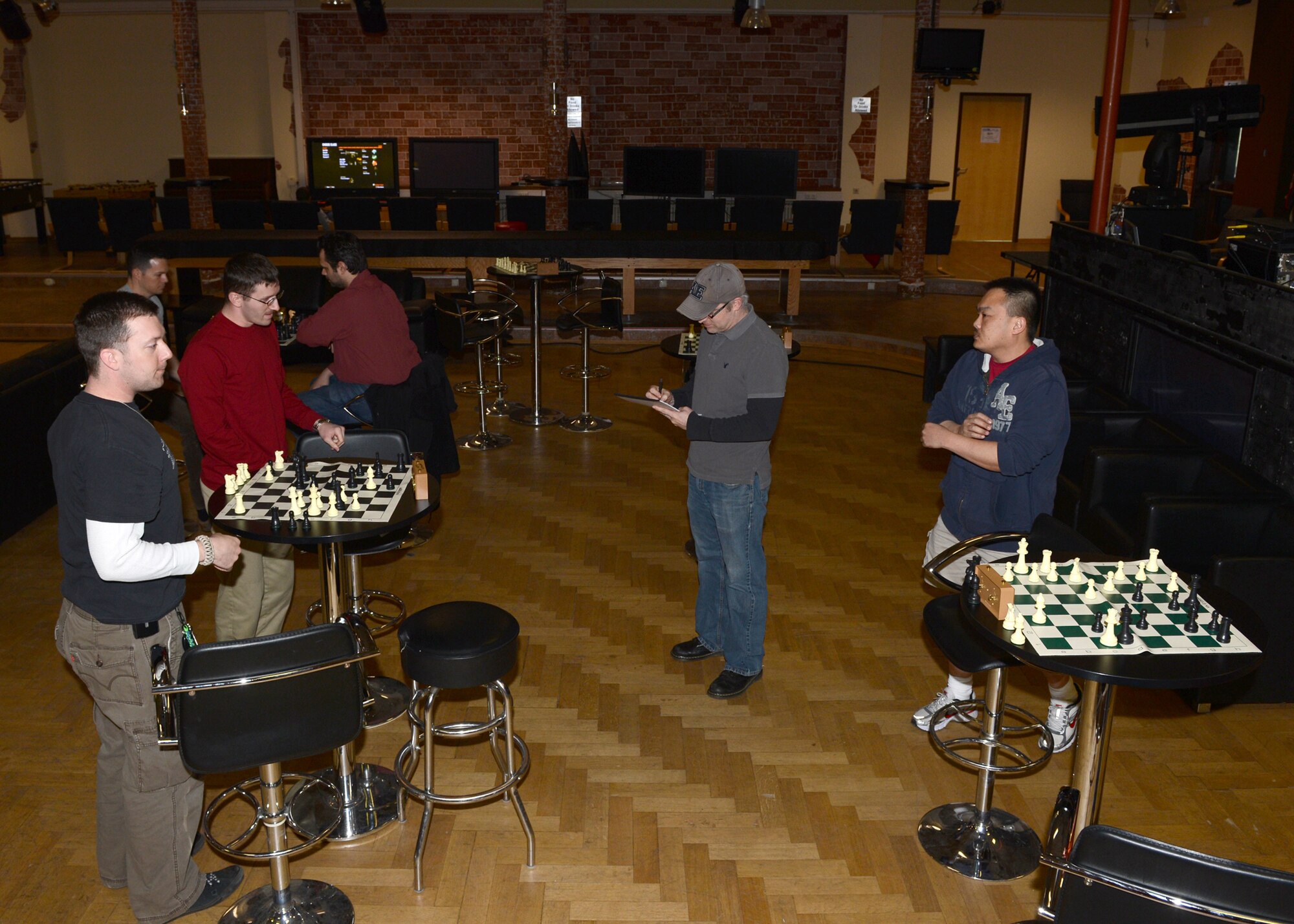 SPANGDAHLEM AIR BASE, Germany – U.S. Air Force Airmen and families gather to play in a chess tournament in the Brick House at Spangdahlem Air Base March 24, 2013. The tournament was hosted by the 52nd Force Support Squadron Community Center. The prizes included $150 for second place and an empty wine barrel for the first-place winner. (U.S. Air Force photo by Airman 1st Class Kyle Gese/Released)