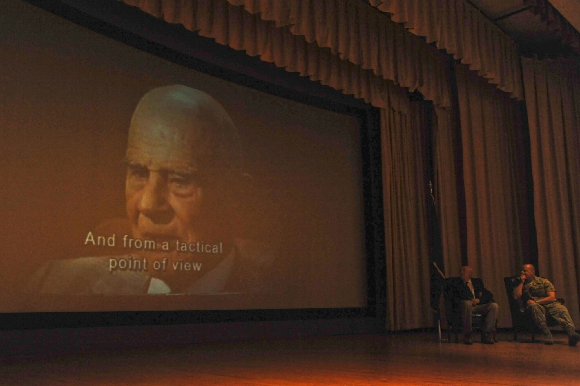 U.S. Air Force Col. Mark Damiano, 17th Training Wing commander, and retired Lt. Col. Richard Cole, Doolittle Raider, watch a clip of 30 Second Over Tokyo at the Goodfellow Air Force base theater March 26, 2013. The Doolittle Raiders were the first team to retaliate for the attack on Pearl Harbor. (U.S. Air Force photo/ Airman 1st Class Michael Smith)