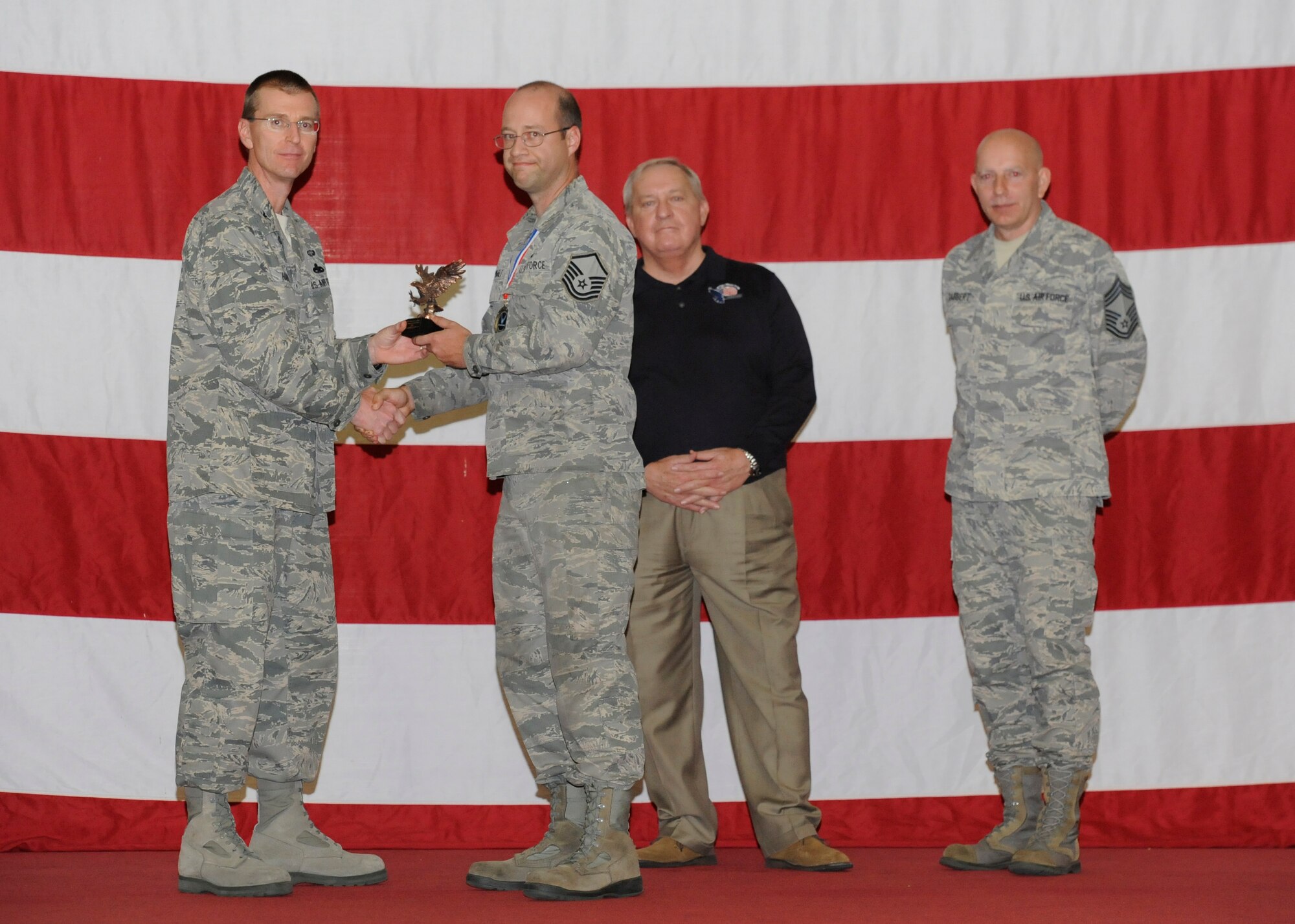 Master Sgt. James Zumwalt recieves the Lt. Gen. Leo Marquez Aircraft Maintenance Manager Award from Col. Curtis Hafer, 325th Maintenance Group commander, and Chief Master Sgt. Terry Gabbert, 325th MXG superintendent, and retired ninth Chief Master Sergeant of the Air Force, Chief Master Sgt. James Binnicker, during the 2012 Maintenance and Staff Professionals of the Year banquet in Hangar 1 March 15. The MPOY banquet recognizes the achievements of the maintenance group and honors maintenance professionals each year. (U.S. Air Force photo by Chris Cokeing)
