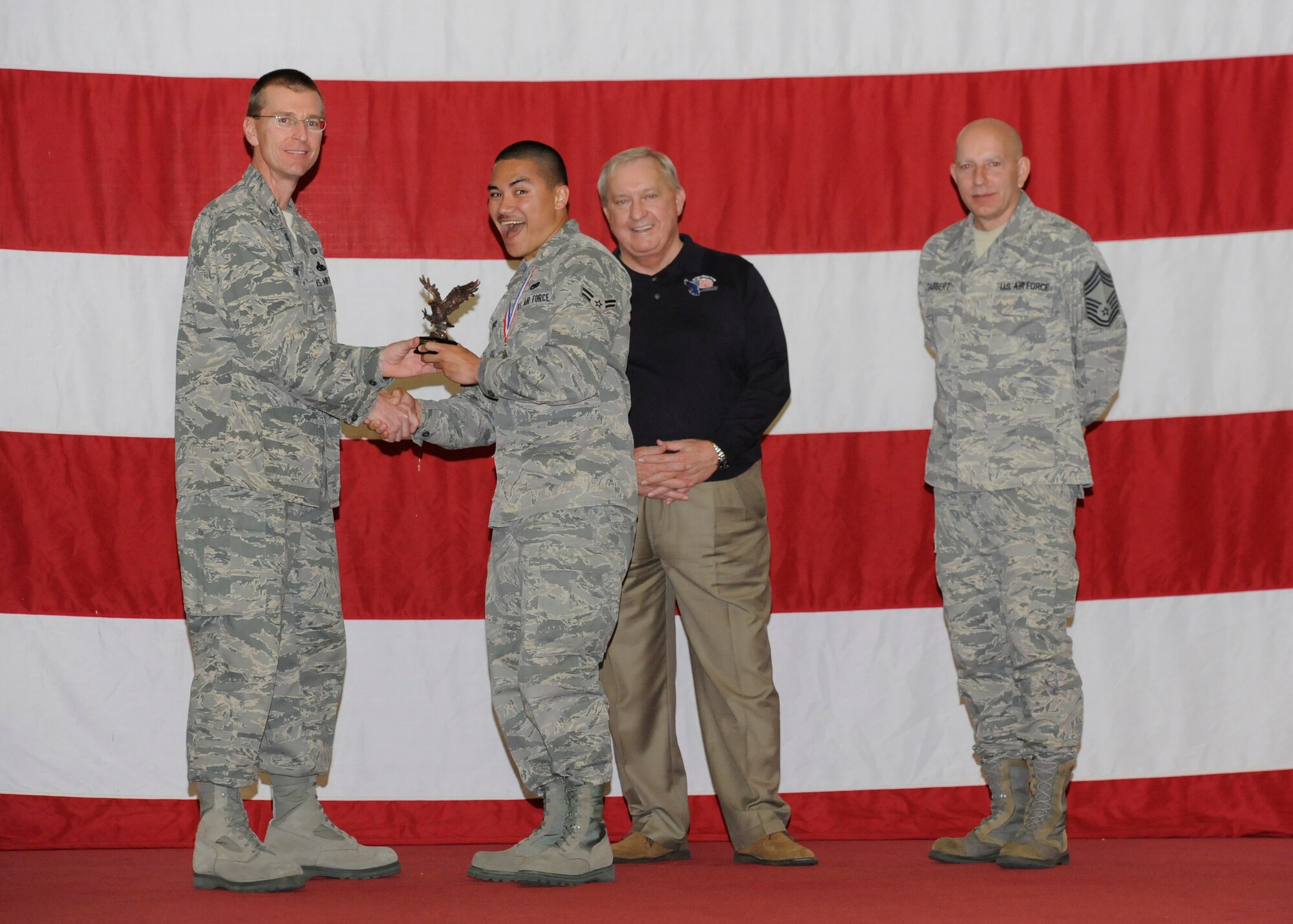 Airman First Class William Trisch recieves the Lt. Gen. Leo Marquez Aircraft Maintenance Technician Award from Col. Curtis Hafer, 325th Maintenance Group commander, and Chief Master Sgt. Terry Gabbert, 325th MXG superintendent, and retired ninth Chief Master Sergeant of the Air Force, Chief Master Sgt. James Binnicker, during the 2012 Maintenance and Staff Professionals of the Year banquet in Hangar 1 March 15. The MPOY banquet recognizes the achievements of the maintenance group and honors maintenance professionals each year. (U.S. Air Force photo by Chris Cokeing)
