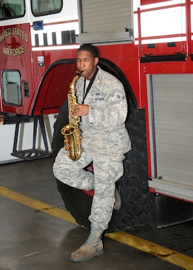 Airman 1st Class Bobby Lucas, 100th Civil Engineer Squadron Fire Department firefighter, plays alto saxophone March 20, 2013, in the fire station bays at RAF Mildenhall, England. Lucas regularly plays around the fire station, entertaining other “fire dawgs.” He recently earned a place as part of the elite Tops in Blue, the U.S. Air Force’s premier entertainment group, and will travel around the world performing for military members and their families. (U.S. Air Force photo by Gina Randall/Released)