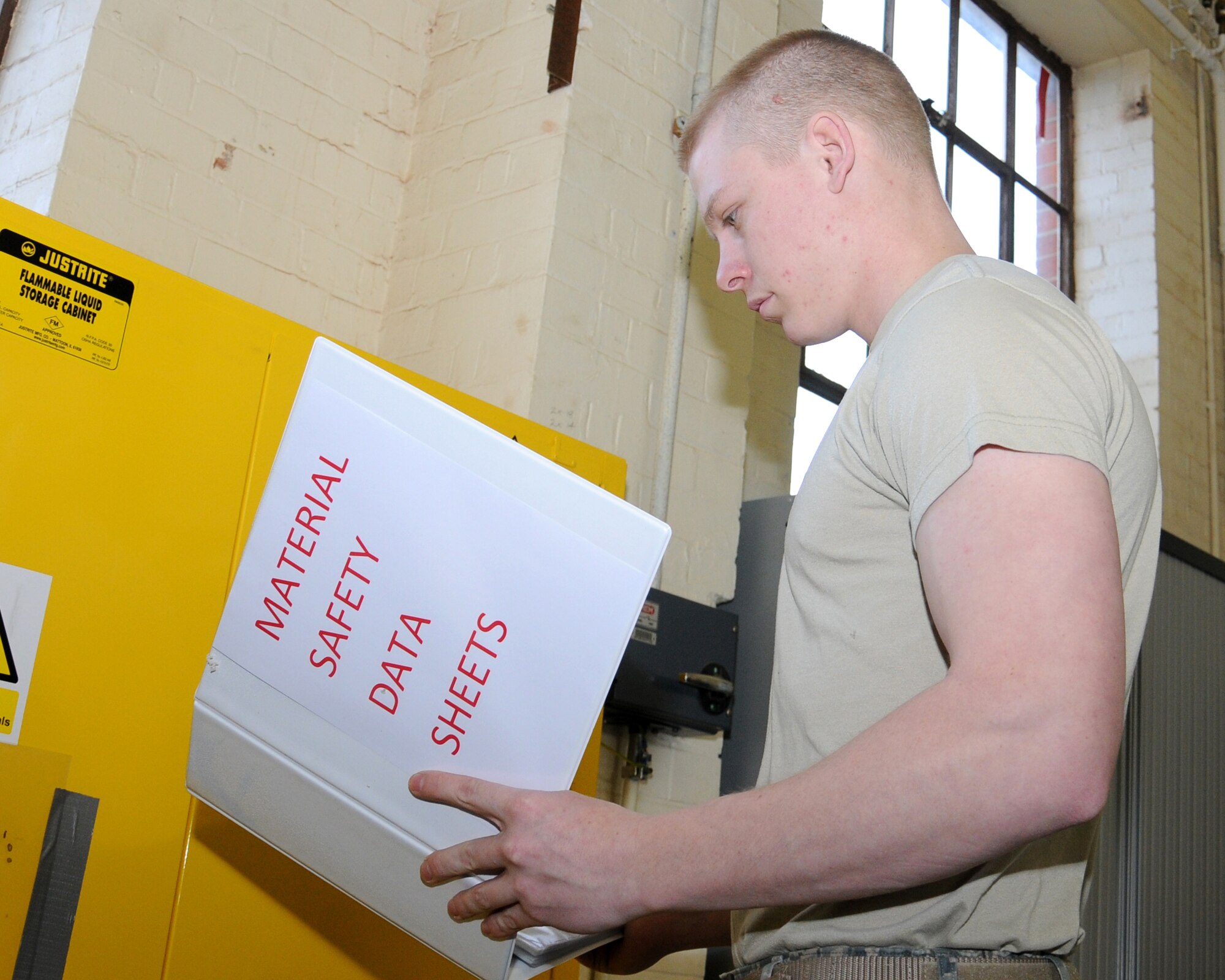 Airman 1st Class Andrew Burdette, 100th Civil Engineer Squadron Water and Fuels Maintenance journeyman from Victorville, Calif., refers to a material safety data sheet prior to performing a task March 13, 2013, at RAF Mildenhall, England. The shop inspects and performs preventative maintenance on all fire prevention systems and fire hydrants, along with maintaining base facilities’ water and wastewater systems. This process ensures the base has fully operational utilities. (U.S. Air Force photo by Gina Randall/Released)