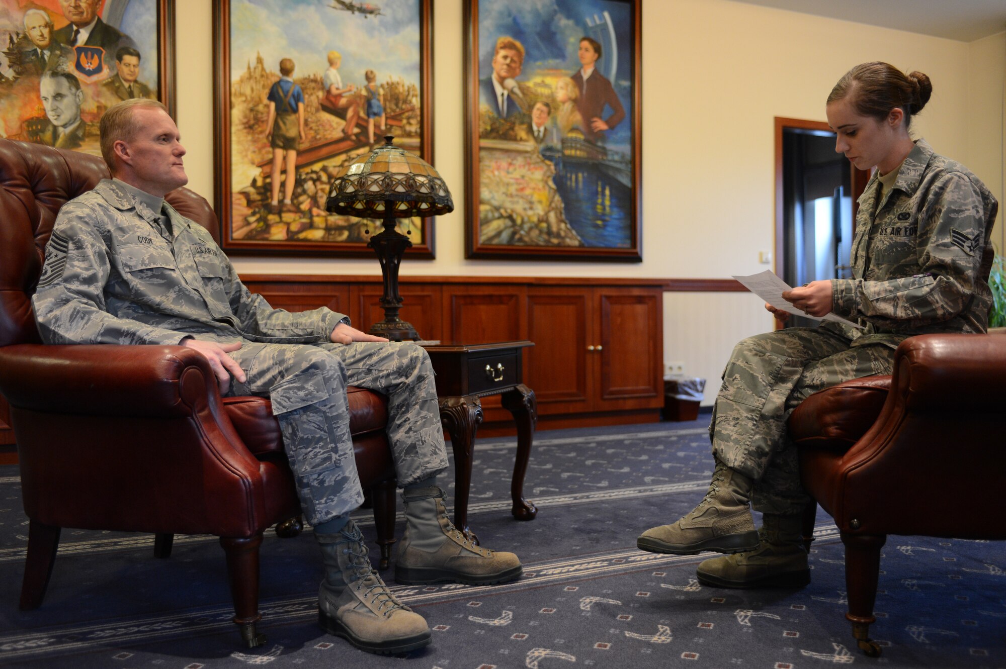 Senior Airman Whitney Stork, 86th Airlift Wing public affairs photojournalist, interviews Chief Master Sgt. of the Air Force James A. Cody during his visit to Ramstein Air Base March 26. Cody visited with members of Team Ramstein to share the Air Force strategic vision. (U.S. Air Force photo/Senior Airman Caitlin O'Neil-McKeown)