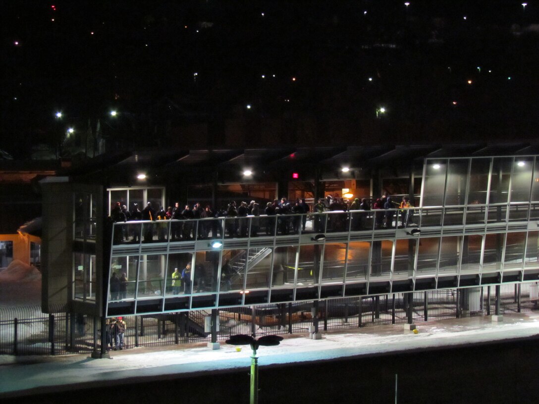 Visitors line up at the top of a viewing platform at the Soo Locks to get a view of the Paul R. Tregurtha as it enters the Poe Lock just after midnight March 25, 2013. The locks opened at 12:01 a.m. to kick off the beginning of the 2013 Great Lakes shipping season.