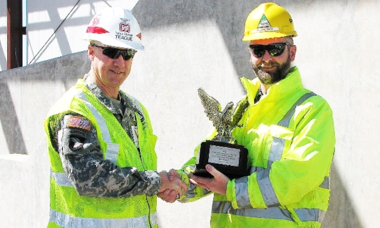 Tulsa District Commander Col. Michael Teague presents the 2012 Eagle Eye Construction Safety Program Award for Contractor of the Year to David Mattson, project manager for the Kiewit Building Group.