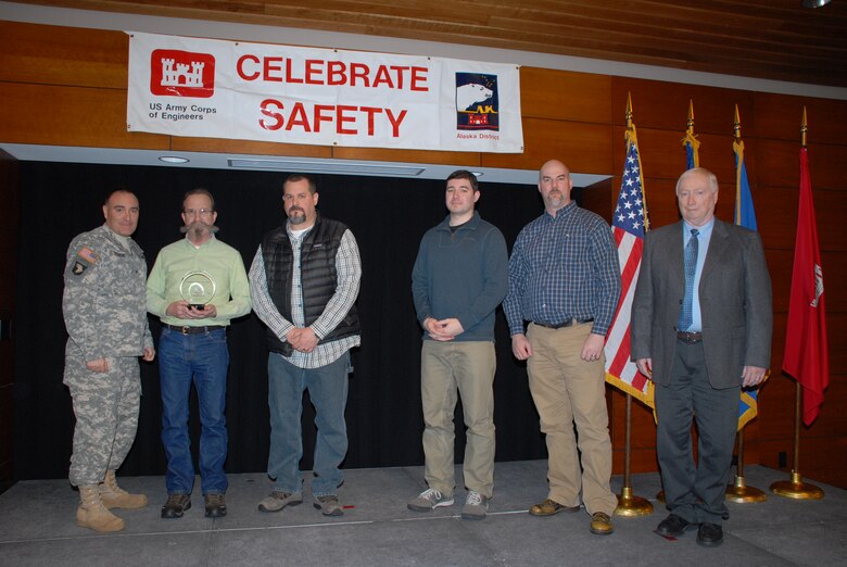 Raymond Peif, site safety health officer and contractor quality control manager for Haskell Corporation, holds the 2012 Celebrate Safety Contractor of the Year Award during a ceremony at Joint Base Elmendorf-Richardson March 27. Surrounding him (from the left) are Col. Christopher Lestochi, district commander; Chris Szolomayer, Haskell Corporation project manager; Andrew Posma, Eielson Resident Office project engineer; Jay Klaassen, Eielson Resident Office engineer; and Pat Coullahan, chief of Alaska District's construction-operations division. 