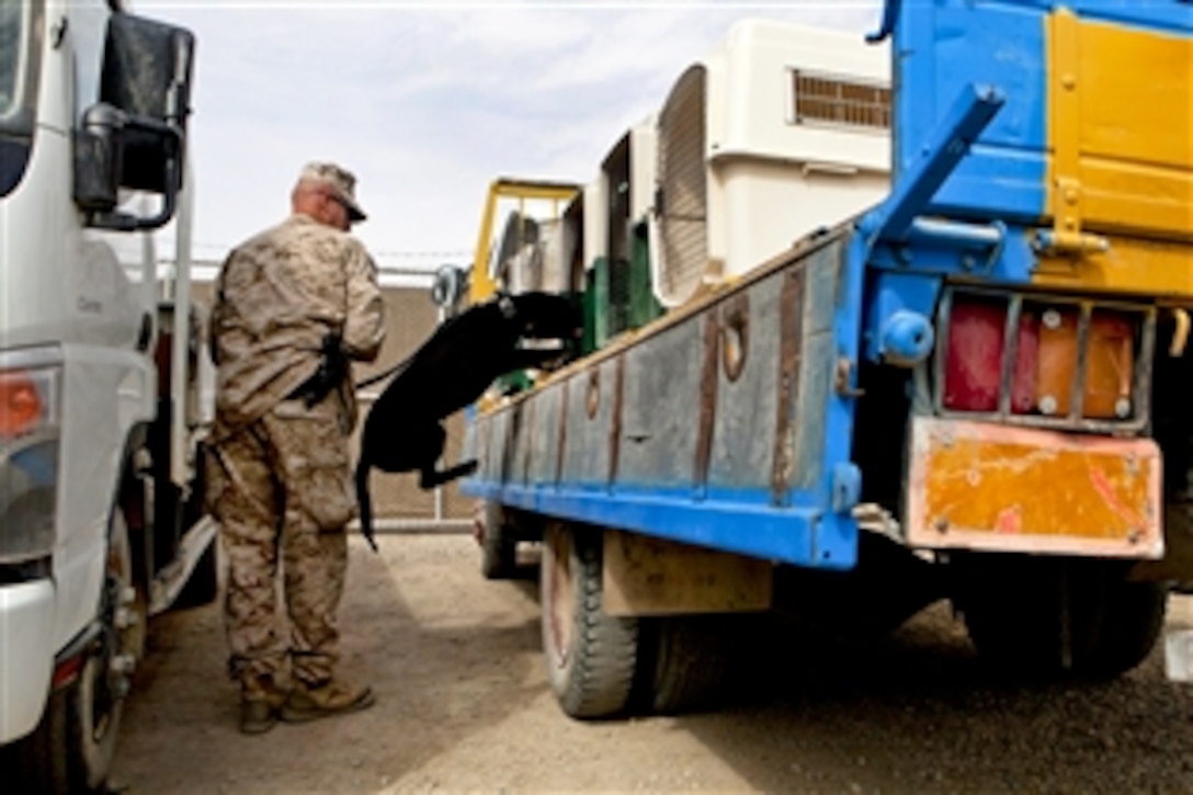 U.S. Marine Corps Staff Sgt. Scott Brown loads Knight, a dog trained to detect improvised explosive devices, into a kennel before a training session on Camp Leatherneck, Afghanistan, March 19, 2013. Brown, a kennel supervisor, is assigned to the 2nd Combat Engineer Battalion.