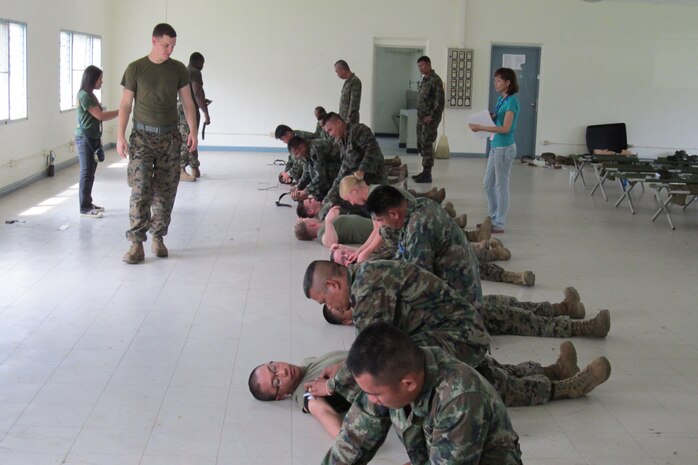 Petty Officer 2nd Class Michael Davis, a battle aid station instructor and hospital corpsman, evaluates tourniquet technique used by U.S. and Royal Thai Marines and sailors during a combat lifesaver class Feb. 18 in Chonburi province, Kingdom of Thailand, part of exercise Cobra Gold 2013. Davis and the U.S. service members are part of Combat Logistics Regiment 3, 3rd Marine Logistics Groups, III Marine Expeditionary Force. Exercise Cobra Gold includes humanitarian and civic assistance projects, a staff exercise and field training exercises. Joint and multinational training is vital to maintaining the readiness and interoperability of all participating military forces. 
