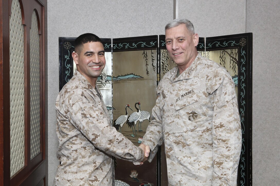 The Assistant Commandant of the Marine Corps, Gen. John M. Paxton, Jr., visits with Marines while on a base tour of Marine Corps Air Station Iwakuni, Japan, March 11, 2013. The tour was hosted by Col. James Stewart. (U.S. Marine Corps photo by Cpl. Tia Dufour/Released)