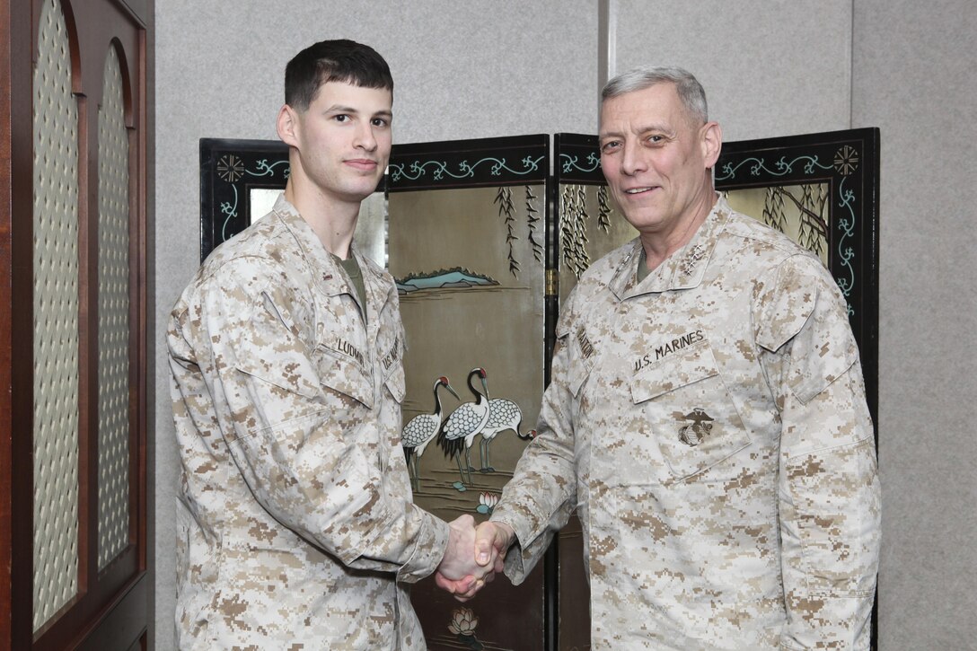 The Assistant Commandant of the Marine Corps, Gen. John M. Paxton, Jr., visits with Marines while on a base tour of Marine Corps Air Station Iwakuni, Japan, March 11, 2013. The tour was hosted by Col. James Stewart. (U.S. Marine Corps photo by Cpl. Tia Dufour/Released)