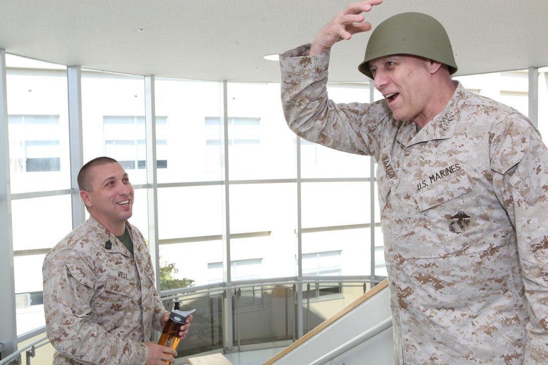 The Assistant Commandant of the Marine Corps, Gen. John M. Paxton, Jr., visits with Marines while on a base tour of Marine Corps Air Station Iwakuni, Japan, March 11, 2013. The tour was hosted by Col. James Stewart. (U.S. Marine Corps photo by Cpl. Tia Dufour/Released)