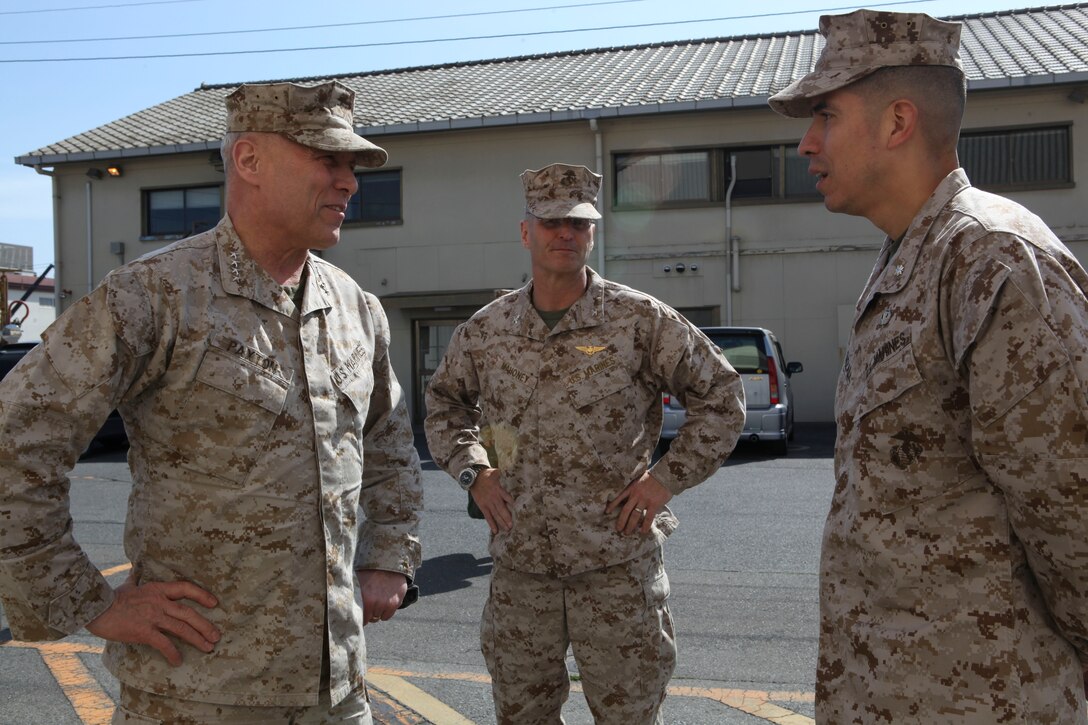 The Assistant Commandant of the Marine Corps, Gen. John M. Paxton, Jr., visits with Marines while on a base tour of Marine Corps Air Station Iwakuni, Japan, March 11, 2013. The tour was hosted by Col. James Stewart. (U.S. Marine Corps photo by Cpl. Tia Dufour/Released)