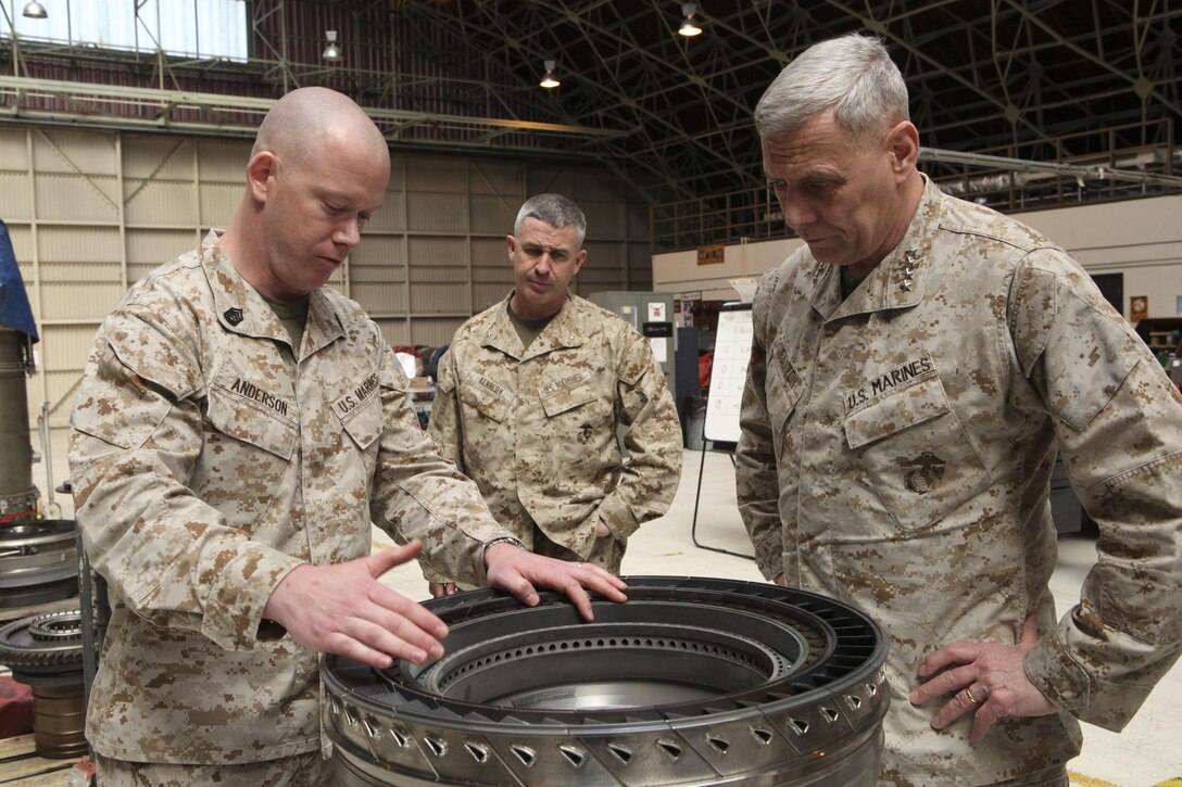The Assistant Commandant of the Marine Corps, Gen. John M. Paxton, Jr., visits with Marines while on a base tour of Marine Corps Air Station Iwakuni, Japan, March 11, 2013. The tour was hosted by Col. James Stewart. (U.S. Marine Corps photo by Cpl. Tia Dufour/Released)