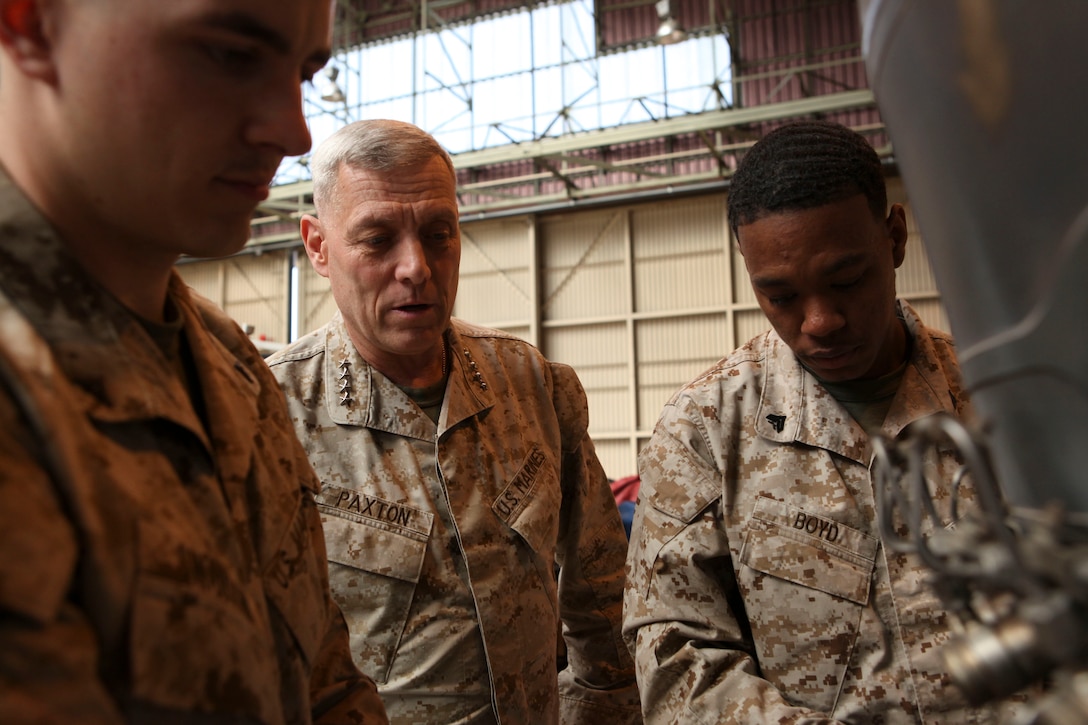 The Assistant Commandant of the Marine Corps, Gen. John M. Paxton, Jr., visits with Marines while on a base tour of Marine Corps Air Station Iwakuni, Japan, March 11, 2013. The tour was hosted by Col. James Stewart. (U.S. Marine Corps photo by Cpl. Tia Dufour/Released)