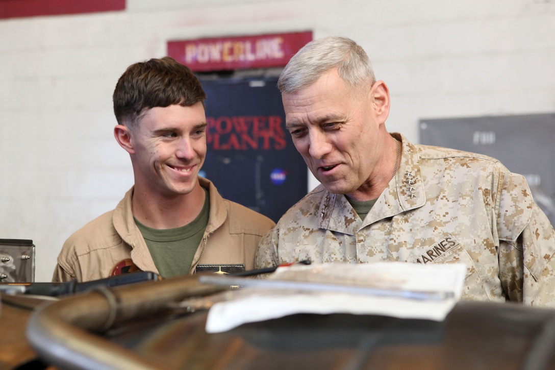 The Assistant Commandant of the Marine Corps, Gen. John M. Paxton, Jr., visits with Marines while on a base tour of Marine Corps Air Station Iwakuni, Japan, March 11, 2013. The tour was hosted by Col. James Stewart. (U.S. Marine Corps photo by Cpl. Tia Dufour/Released)