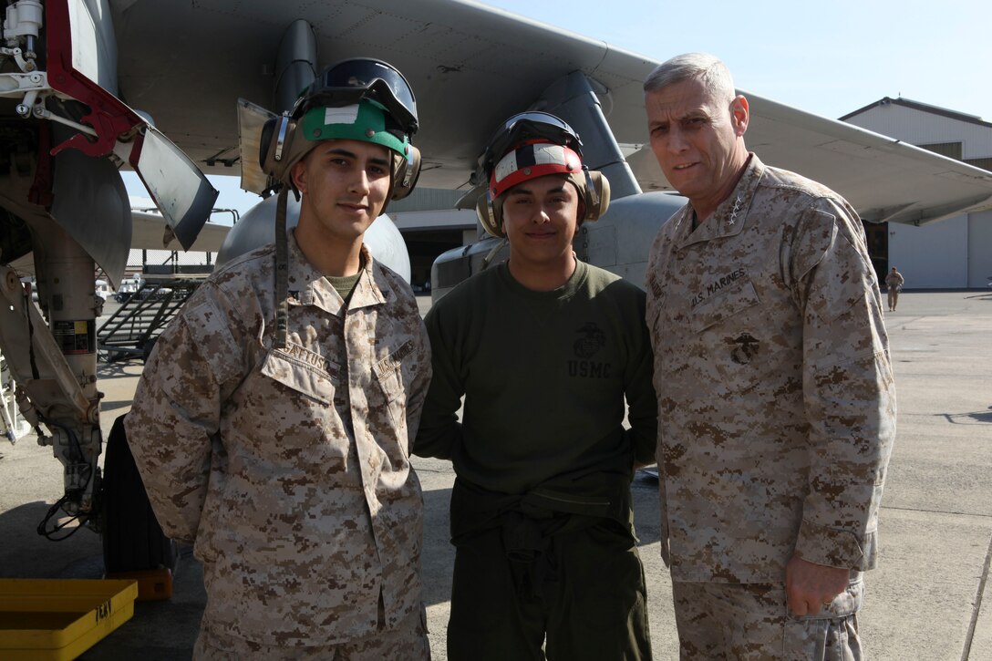 The Assistant Commandant of the Marine Corps, Gen. John M. Paxton, Jr., poses for a photo with Marines while on a base tour of Marine Corps Air Station Iwakuni, Japan, March 11, 2013. The tour was hosted by Col. James Stewart. (U.S. Marine Corps photo by Cpl. Tia Dufour/Released)