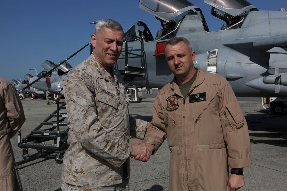 The Assistant Commandant of the Marine Corps, Gen. John M. Paxton, Jr., visits with Marines while on a base tour of Marine Corps Air Station Iwakuni, Japan, March 11, 2013. The tour was hosted by Col. James Stewart. (U.S. Marine Corps photo by Cpl. Tia Dufour/Released)