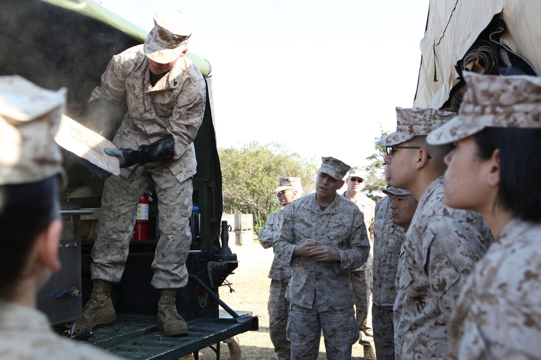 The Assistant Commandant of the Marine Corps, Gen. John M. Paxton, Jr., visits with Marines while on a base tour of Marine Corps Air Station Iwakuni, Japan, March 11, 2013. The tour was hosted by Col. James Stewart. (U.S. Marine Corps photo by Cpl. Tia Dufour/Released)