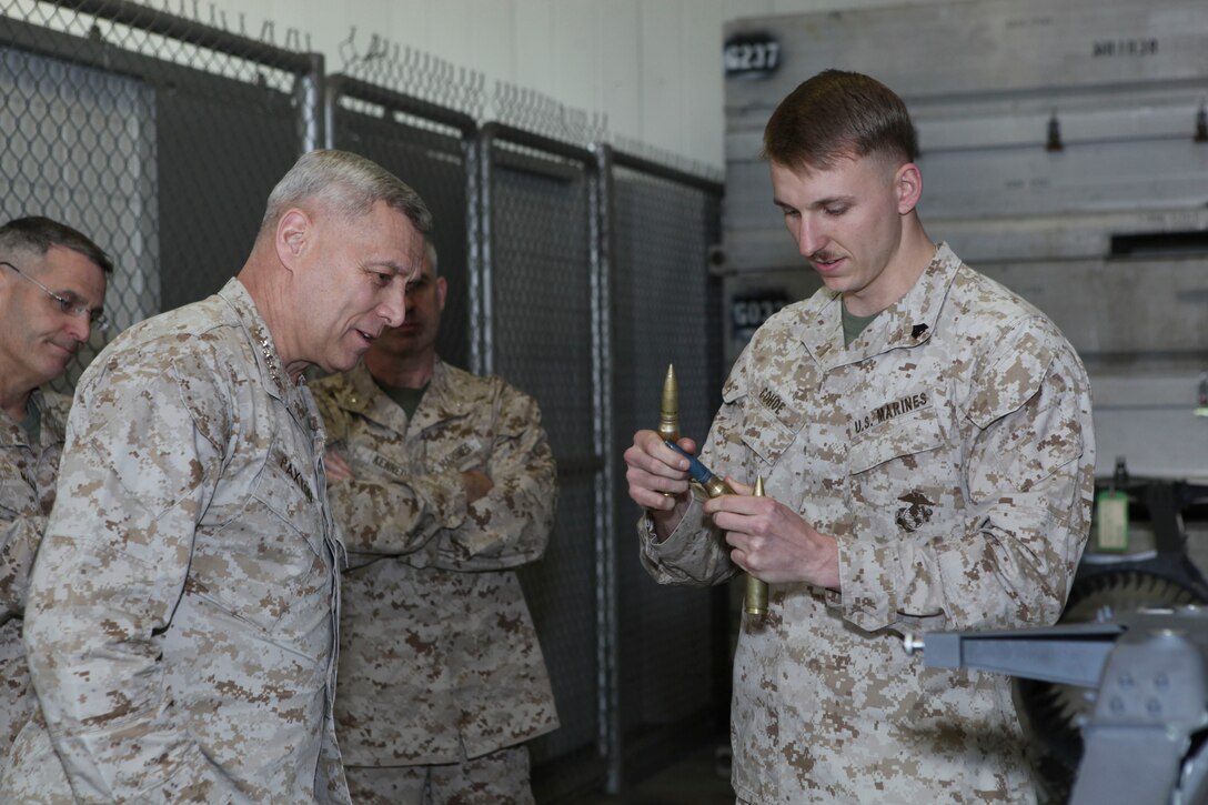 The Assistant Commandant of the Marine Corps, Gen. John M. Paxton, Jr., visits with Marines while on a base tour of Marine Corps Air Station Iwakuni, Japan, March 11, 2013. The tour was hosted by Col. James Stewart. (U.S. Marine Corps photo by Cpl. Tia Dufour/Released)