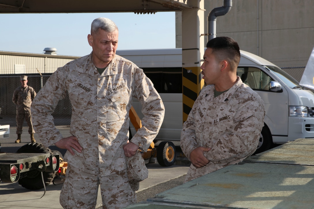 The Assistant Commandant of the Marine Corps, Gen. John M. Paxton, Jr., visits with Marines while on a base tour of Marine Corps Air Station Iwakuni, Japan, March 11, 2013. The tour was hosted by Col. James Stewart. (U.S. Marine Corps photo by Cpl. Tia Dufour/Released)