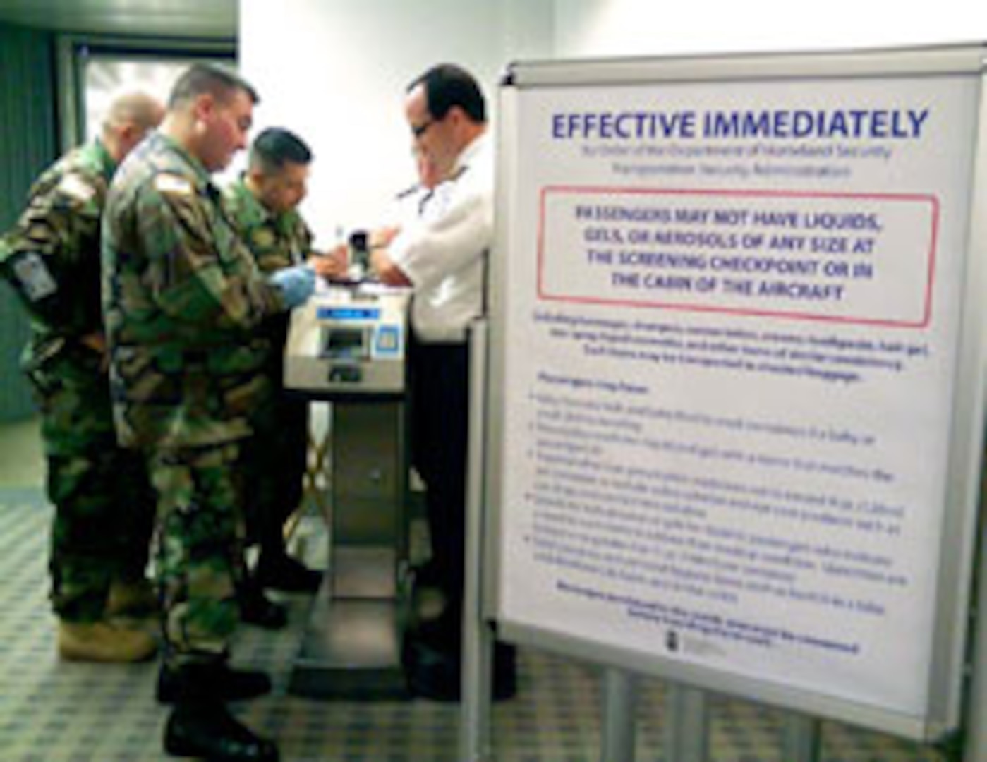 Spc. John Rivera from 40th Special Troop Brigade, foreground; Spc. Gabriel Gambone from the 670th Military Police Company, background; and another California National Guardsman work side by side with officials from the Transportation Security Administration at San Diego International Airport to enforce airport security.