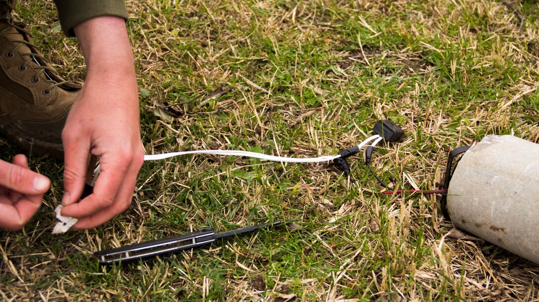 Corporal Steven B. Dungan, Combat Engineer assigned to Combat Logistics Battalion (CLB) 26, 26th Marine Expeditionary Unit (MEU), sets up a mock improvised explosive device (IED), during a counter-IED training exercise, Vaziani Airbase, Republic of Georgia, during exercise Agile Spirit 13, March 23, 2013. The 26th MEU is deploying to the 5th and 6th Fleets area of operations. The 26th MEU operates continuously across the globe, providing the president and unified combatant commanders with a forward-deployed, sea-based quick reaction force. The MEU is a Marine Air-Ground Task Force capable of conducting amphibious operations, crisis response and limited contingency operations. (U.S. Marine Corps motion media by Lance Cpl. Juanenrique Owings/Released)