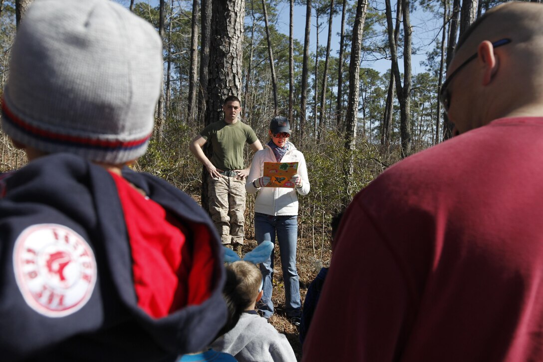 MARINE CORPS AIR STATION CHERRY POINT, N.C. (130325) – Samantha Cook, the Marine Tactical Electronic Warfare Squadron 1 family readiness officer, guides Marine Aircraft Group 14 personnel and families through the Easter trail as a part of the MAG-14 Easter extravaganza at the Shady Grove A camping area at Cherry Point March 23.