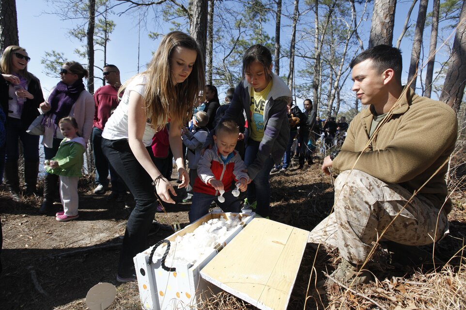 MARINE CORPS AIR STATION CHERRY POINT, N.C. (130325) – Children grab bad bunny bombs at the Marine Aircraft Group 14 Easter extravaganza at the Shady Grove A camping area at Cherry Point March 23. The bad bunny bombs were flour wrapped in tissue that made a sizeable puff on impact. 