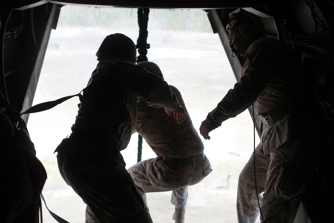 Marines with Special Operations Training Group gather a rope descending from an MV-22B Osprey flown by Marines with Medium Tiltrotor Training Squadron 263 during rappelling and fast-roping training, March 21. The Marines rappelled and fast-roped out of the Osprey 50 feet above ground during the training. 

