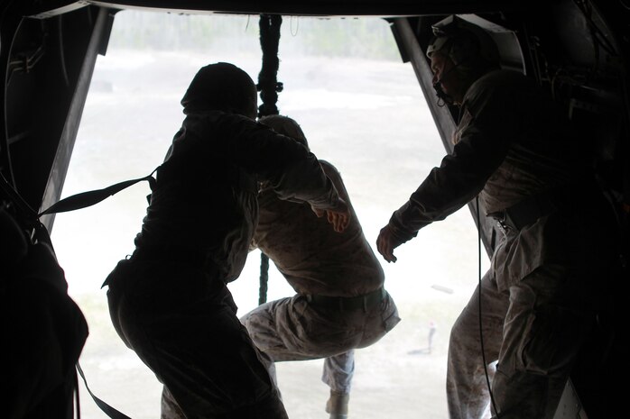 Marines with Special Operations Training Group gather a rope descending from an MV-22B Osprey flown by Marines with Medium Tiltrotor Training Squadron 263 during rappelling and fast-roping training, March 21. The Marines rappelled and fast-roped out of the Osprey 50 feet above ground during the training. 
