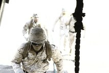 Marines with Special Operations Training Group gather a rope descending from an MV-22B Osprey flown by Marines with Medium Tiltrotor Training Squadron 263 during rappelling and fast-roping training, March 21. The Marines rappelled and fast-roped out of the Osprey 50 feet above ground during the training. 
