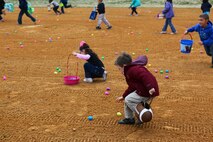 Children of Marines from Marine Aircraft Group 29 run and grab eggs filled with candy during an Easter egg hunt and family day aboard Marine Corps Air Station New River, March 23.