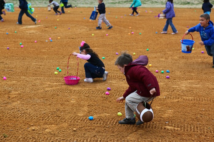 Children of Marines from Marine Aircraft Group 29 run and grab eggs filled with candy during an Easter egg hunt and family day aboard Marine Corps Air Station New River, March 23.