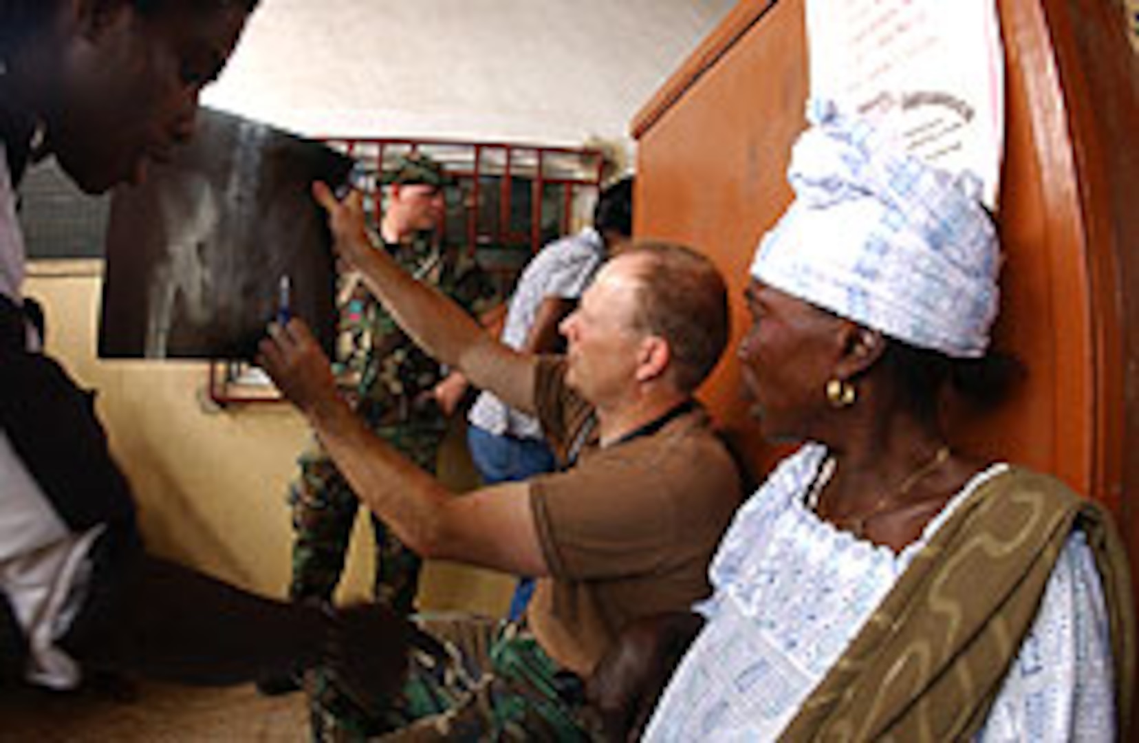 U.S Air Force flight surgeon Lt. Col. Bryan DeLage (119th Medical Group) shows patient Amena Salifu the x-ray of her hip fracture at the Mallam-Atta Market Government Clinic as part of the Medflag 2006 joint force humanitarian medical assistance exercise Accra, Ghana Sep. 13. Amena Salifu walked to the clinic on the broken hip to be examined. The North Dakota National Guard medical group members and support personnel are in Ghana as part of Medflag 2006, which is a U.S. military medical exercise that is geared toward gaining and providing training and experience in management of world health problems, sharing of medical information and techniques with African host countries, and providing humanitarian civic assistance to host nation civilian populations as good will ambassadors of the United States.