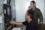 Tech Sgt. Donald Taylor (front), 266th Range Squadron ground radar technician, coordinates simulated threat signals with 1st Lt. Monty Moncrief, 23rd Expeditionary Bomb Squadron electronic warfare officer. The Multiple Threat Emitter System shapes radio wave pulses to look like signals radiated by aircraft threats, such as surface-to-air missiles.